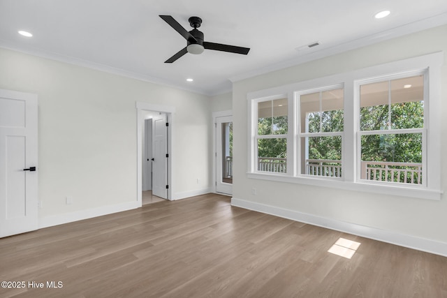 808 S 2nd St, Carolina Beach, NC 28428 - empty room with healthy amount of natural light, ceiling fan, ornamental molding, baseboards, and wood finished floors