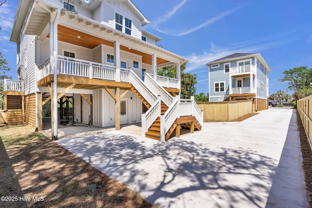 808 S 2nd St, Carolina Beach, NC 28428 - back of house featuring stairs, board and batten siding, a carport, and covered porch