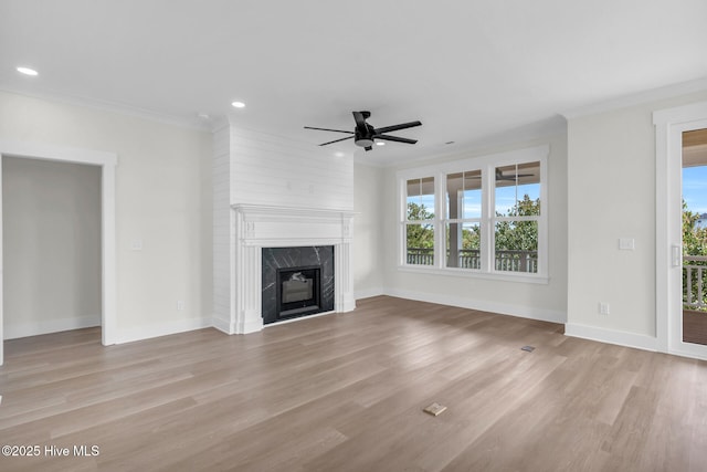 808 S 2nd St, Carolina Beach, NC 28428 - unfurnished living room with a ceiling fan, light wood-style flooring, recessed lighting, a premium fireplace, and baseboards