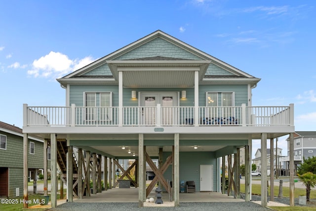 1711 S Anderson Blvd, Holly Ridge, NC 28445 - beach home with a carport, driveway, a porch, and stairway