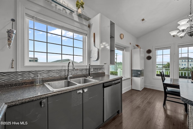 1711 S Anderson Blvd, Holly Ridge, NC 28445 - kitchen with dishwasher, dark countertops, vaulted ceiling, a chandelier, and dark wood finished floors