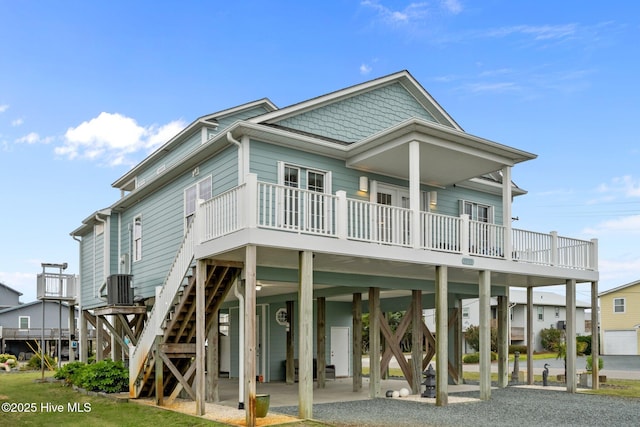 1711 S Anderson Blvd, Holly Ridge, NC 28445 - back of property featuring a carport, gravel driveway, stairway, a wooden deck, and central AC