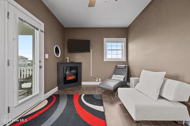 1711 S Anderson Blvd, Holly Ridge, NC 28445 - sitting room featuring wood finish floors, ceiling fan, baseboards, and a glass covered fireplace