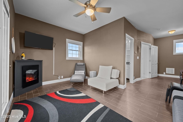 1711 S Anderson Blvd, Holly Ridge, NC 28445 - living area featuring baseboards, plenty of natural light, and a ceiling fan