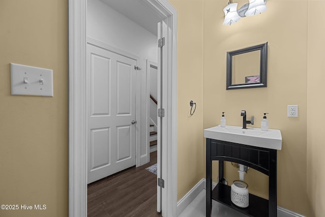 1711 S Anderson Blvd, Holly Ridge, NC 28445 - bathroom featuring baseboards, wood finished floors, and a sink
