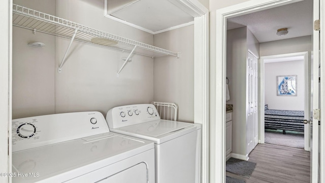 227 Foxkroft Dr Unit 9, Foxfire Village, NC 27281 - laundry room with washing machine and dryer, light wood-style flooring, and baseboards
