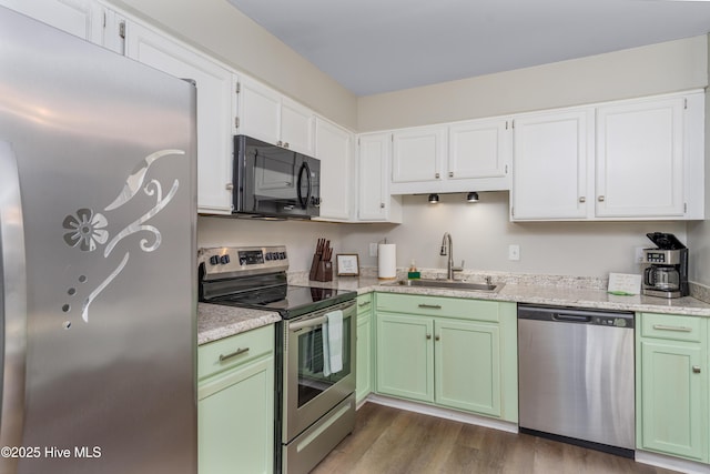 4 Port W Ct Unit C, Swansboro, NC 28584 - kitchen featuring appliances with stainless steel finishes, green cabinetry, dark wood-style floors, and white cabinetry