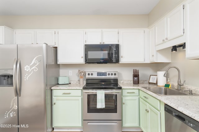 4 Port W Ct Unit C, Swansboro, NC 28584 - kitchen with appliances with stainless steel finishes, white cabinets, and green cabinetry