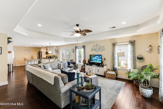 131 NE 33rd St, Oak Island, NC 28465 - living room featuring a tray ceiling, ceiling fan, dark wood-type flooring, baseboards, and recessed lighting