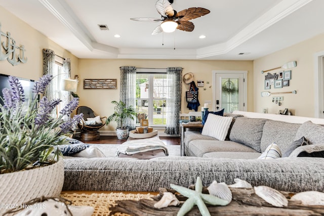 131 NE 33rd St, Oak Island, NC 28465 - living room featuring a raised ceiling, ceiling fan, wood finished floors, baseboards, and recessed lighting