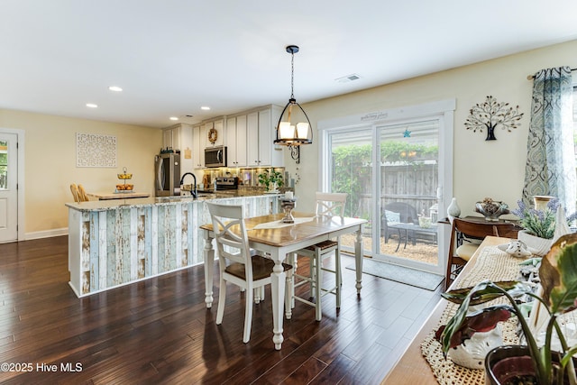 131 NE 33rd St, Oak Island, NC 28465 - dining space featuring dark wood finished floors, recessed lighting, and baseboards