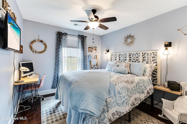 131 NE 33rd St, Oak Island, NC 28465 - bedroom with baseboards, wood finished floors, and a ceiling fan