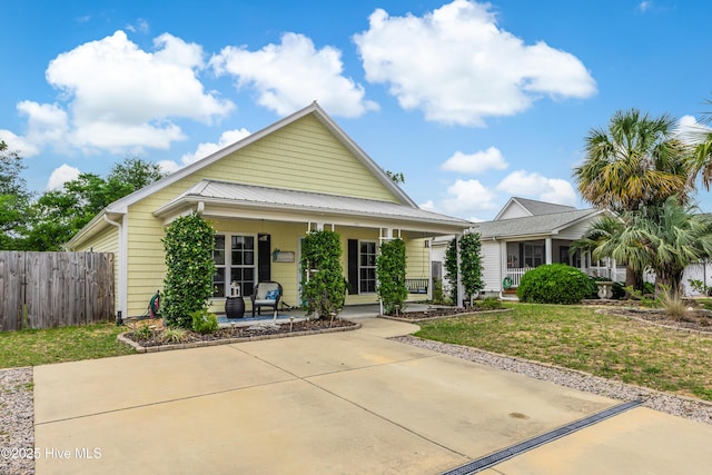 131 NE 33rd St, Oak Island, NC 28465 - view of front of home featuring a porch