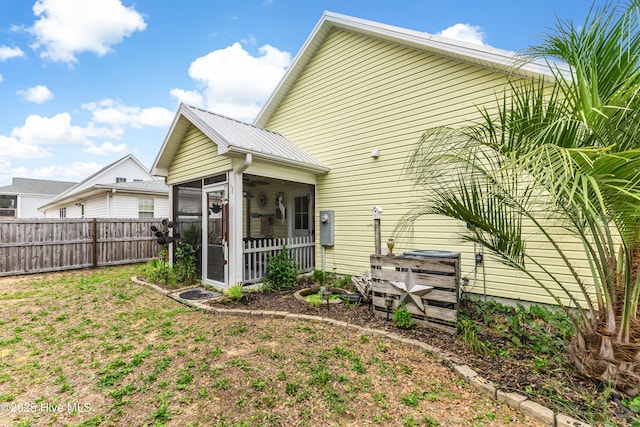 131 NE 33rd St, Oak Island, NC 28465 - back of house featuring a sunroom