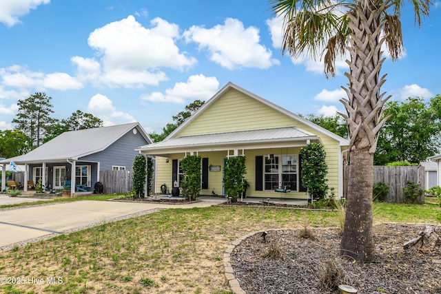 131 NE 33rd St, Oak Island, NC 28465 - view of front facade with a porch