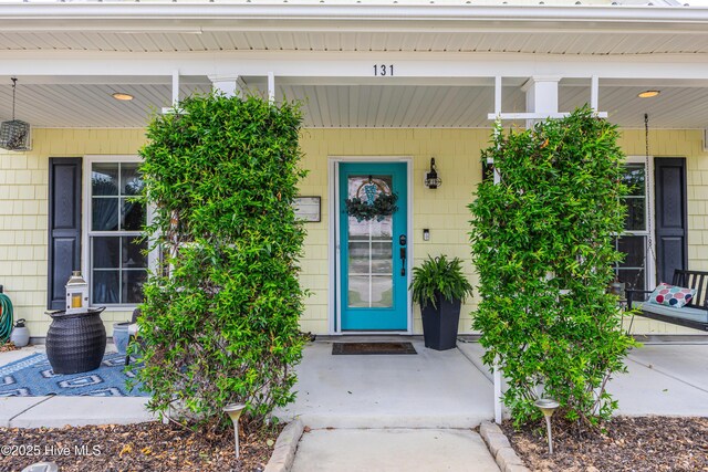 131 NE 33rd St, Oak Island, NC 28465 - entrance to property with a porch