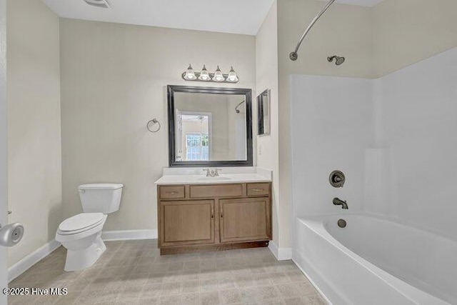bathroom featuring baseboards, washtub / shower combination, toilet, and vanity
