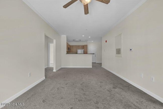 unfurnished living room with ceiling fan, carpet flooring, baseboards, ornamental molding, and recessed lighting