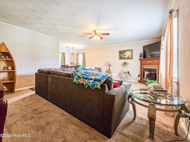 889 NC Highway 37 N, Gates, NC 27937 - living room with a ceiling fan, carpet floors, crown molding, a fireplace with raised hearth, and baseboards
