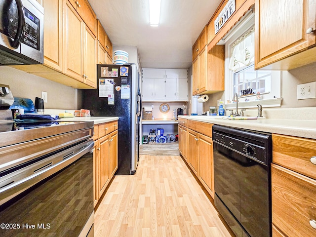 889 NC Highway 37 N, Gates, NC 27937 - kitchen featuring stainless steel appliances, light wood-style flooring, a sink, and light countertops