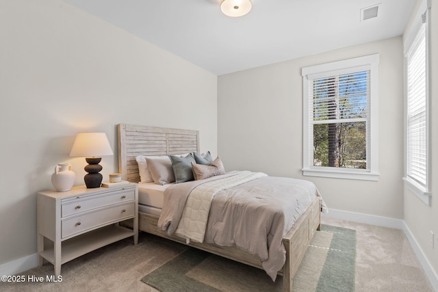 bedroom with multiple windows, carpet flooring, and baseboards