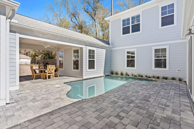 outdoor pool featuring a patio and fence