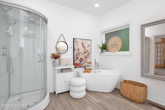 181 Kirkpatrick Ln, Red Springs, NC 28377 - full bathroom featuring a shower stall, wood finished floors, baseboards, a freestanding bath, and recessed lighting