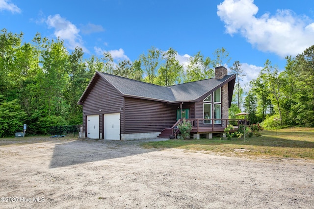 181 Kirkpatrick Ln, Red Springs, NC 28377 - view of front of home featuring a chimney, a deck, and a shingled roof