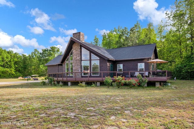 181 Kirkpatrick Ln, Red Springs, NC 28377 - back of property with a chimney, a deck, a lawn, and roof with shingles