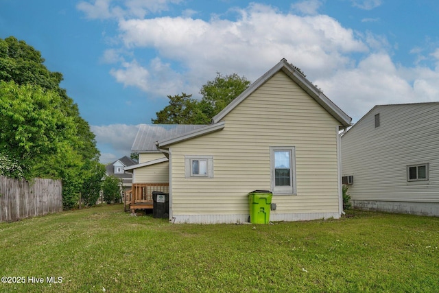 rear view of house featuring metal roof and a wooden deck