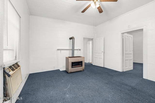 unfurnished living room with a wood stove, heating unit, ceiling fan, dark carpet, and cooling unit