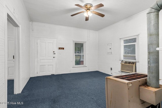 carpeted spare room featuring ceiling fan, plenty of natural light, and ornamental molding