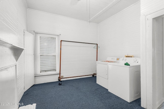 clothes washing area with washing machine and dryer, carpet floors, and attic access