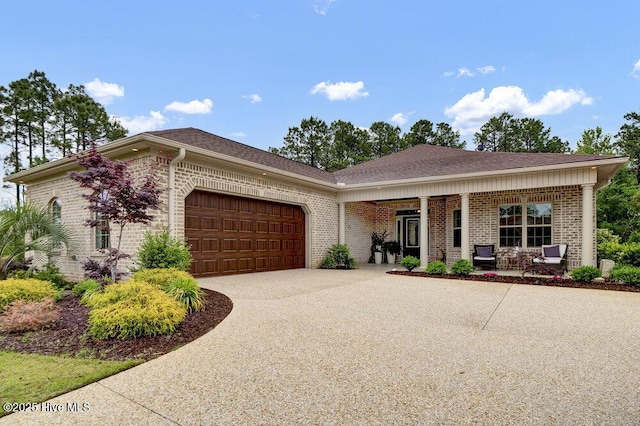 376 Glenn Ellen Dr, Wilmington, NC 28412 - ranch-style house with an attached garage, brick siding, covered porch, concrete driveway, and a shingled roof