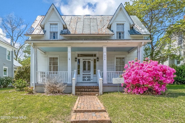 306 S Oakum St, Edenton, NC 27932 - view of front facade featuring covered porch, a front yard, and a standing seam roof