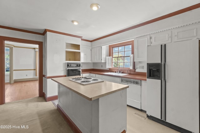 306 S Oakum St, Edenton, NC 27932 - kitchen with white appliances, crown molding, white cabinets, a center island, and a sink