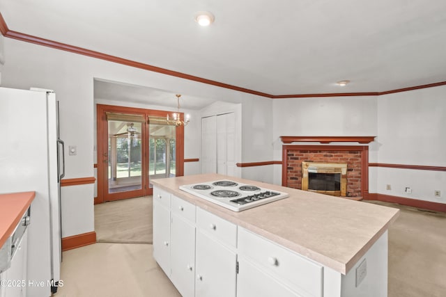 306 S Oakum St, Edenton, NC 27932 - kitchen with white appliances, white cabinets, light countertops, a chandelier, and baseboards