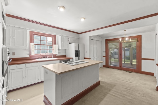 306 S Oakum St, Edenton, NC 27932 - kitchen featuring white appliances, a sink, white cabinets, a kitchen island, and pendant lighting
