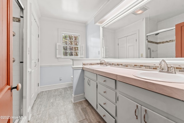 306 S Oakum St, Edenton, NC 27932 - bathroom with a shower stall, double vanity, crown molding, toilet, and tasteful backsplash