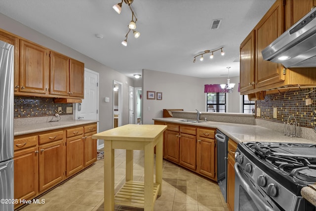 kitchen with range hood, a sink, stainless steel appliances, light countertops, and light tile patterned floors