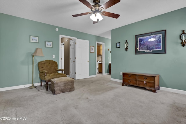 living area featuring a ceiling fan, baseboards, and carpet