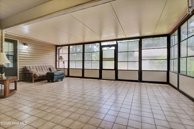 sunroom / solarium with healthy amount of natural light and tile patterned flooring