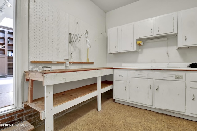 kitchen with white cabinets and light countertops