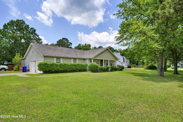 single story home featuring a front lawn, a garage, and concrete driveway
