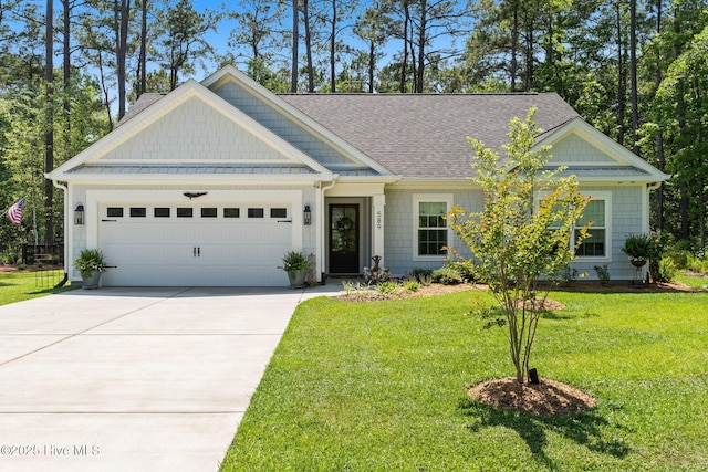 craftsman house with a garage, driveway, roof with shingles, and a front lawn