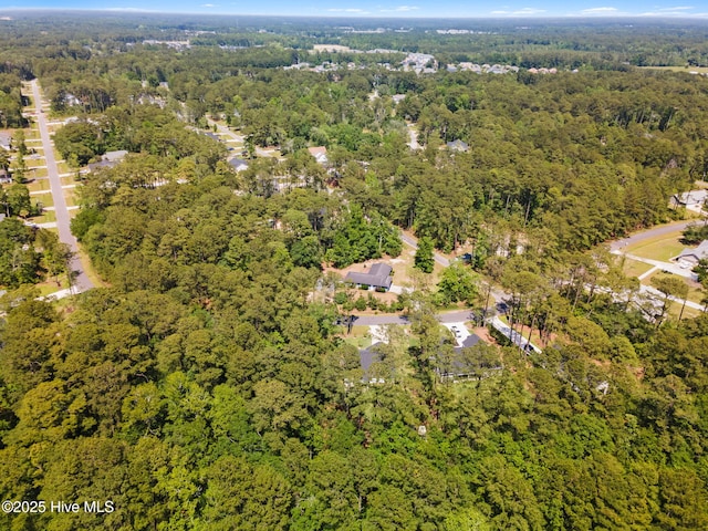 view of property location with a heavily wooded area