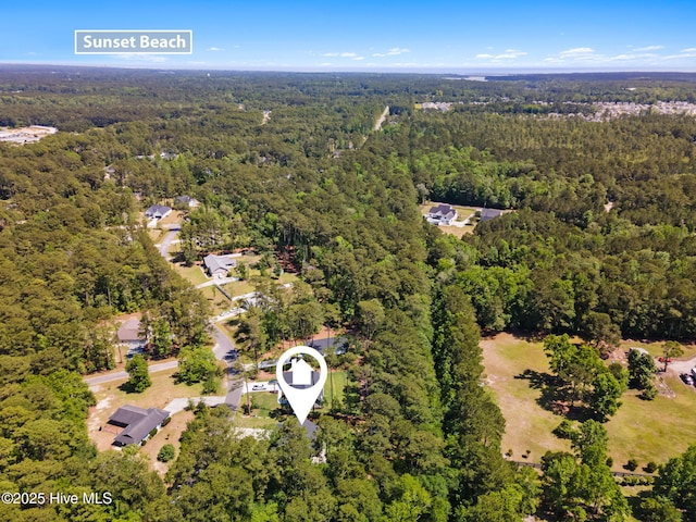 view of property location with a heavily wooded area
