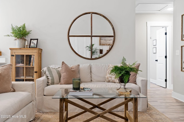 living room with light wood-type flooring and baseboards