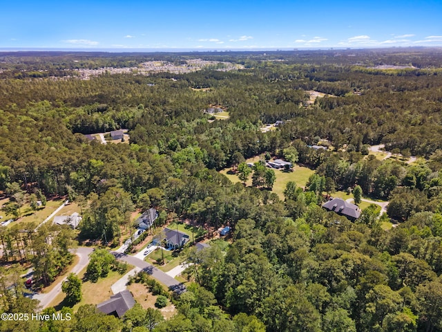 aerial overview of property's location with a heavily wooded area