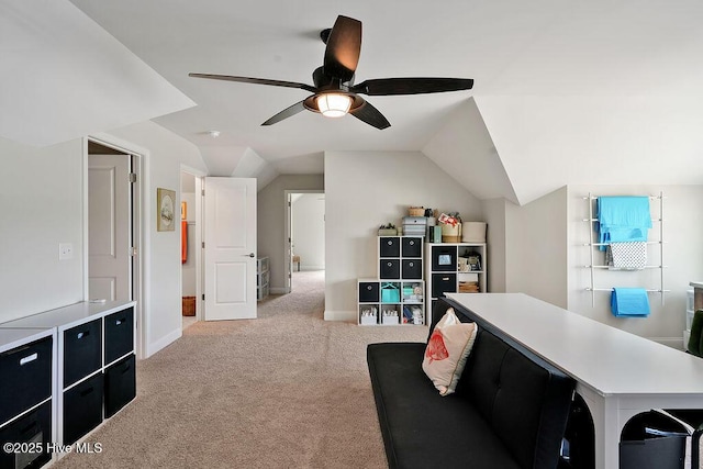 carpeted living area featuring a ceiling fan, vaulted ceiling, and baseboards